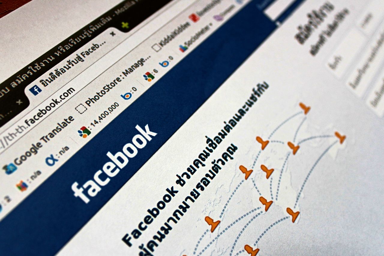why-choose-us Close-up view of a Facebook webpage displayed on a browser with social media icons.